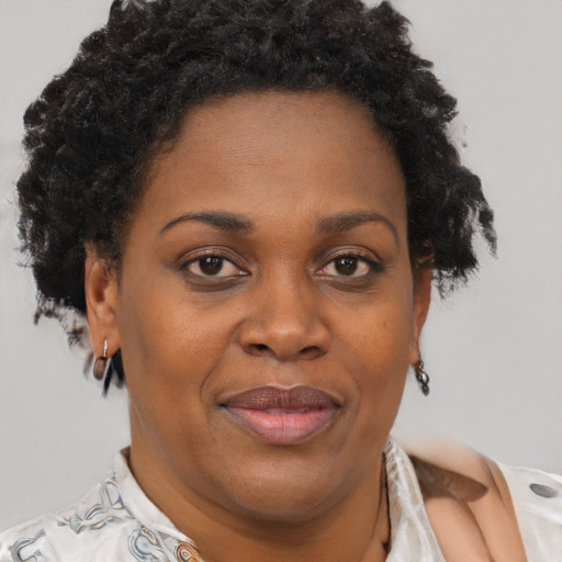 Joyful black adult female with short  brown hair and brown eyes