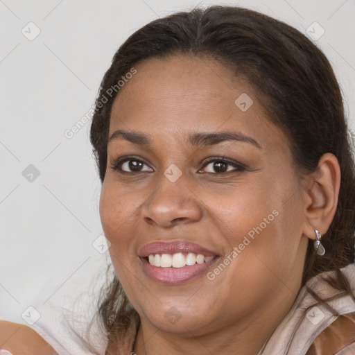 Joyful black adult female with medium  brown hair and brown eyes