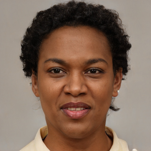 Joyful black adult female with short  brown hair and brown eyes