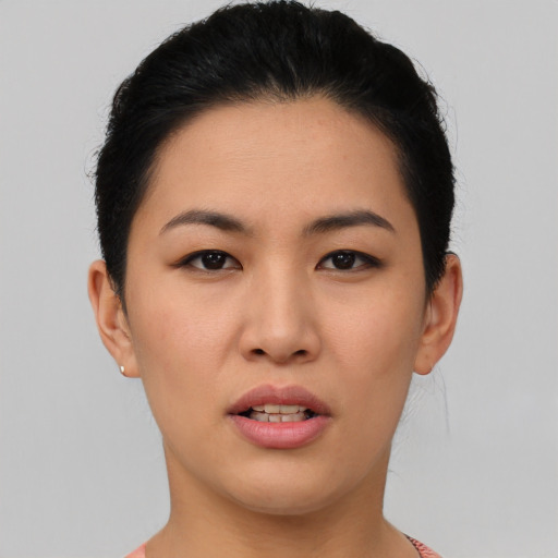 Joyful asian young-adult female with short  black hair and brown eyes