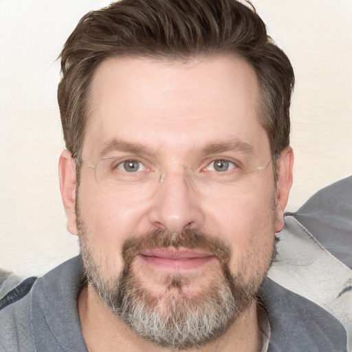 Joyful white adult male with short  brown hair and grey eyes