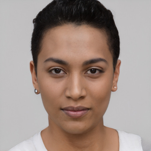 Joyful latino young-adult female with short  brown hair and brown eyes