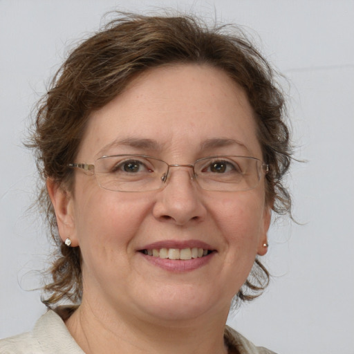 Joyful white adult female with medium  brown hair and grey eyes