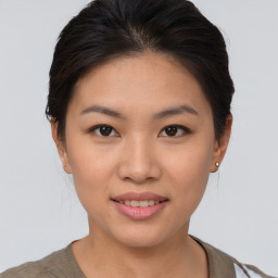 Joyful asian young-adult female with short  brown hair and brown eyes