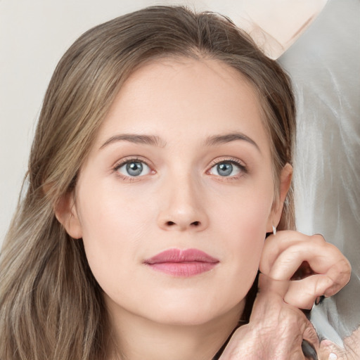 Joyful white young-adult female with medium  brown hair and blue eyes