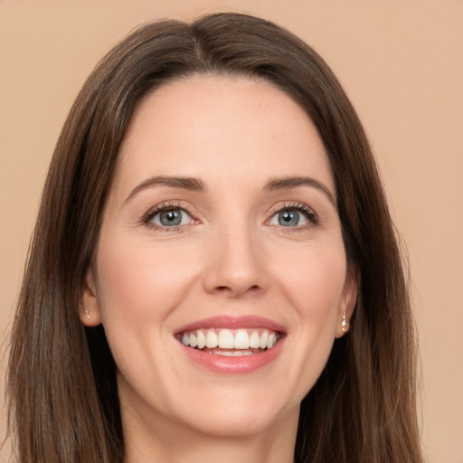 Joyful white young-adult female with long  brown hair and brown eyes