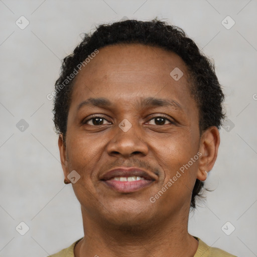 Joyful latino young-adult male with short  brown hair and brown eyes