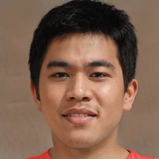 Joyful asian young-adult male with short  black hair and brown eyes