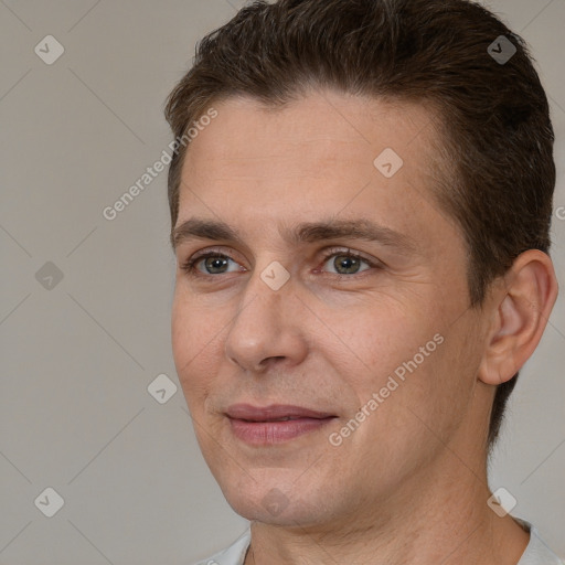 Joyful white adult male with short  brown hair and brown eyes