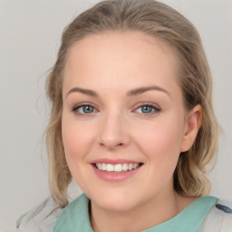 Joyful white young-adult female with medium  brown hair and blue eyes