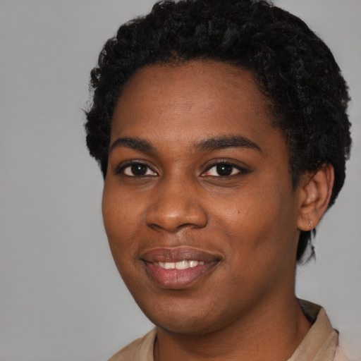 Joyful black young-adult female with short  black hair and brown eyes