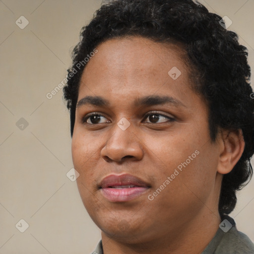 Joyful black young-adult female with short  black hair and brown eyes