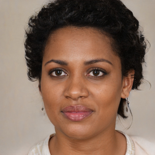 Joyful black young-adult female with medium  brown hair and brown eyes