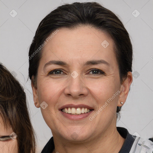 Joyful white adult female with medium  brown hair and brown eyes