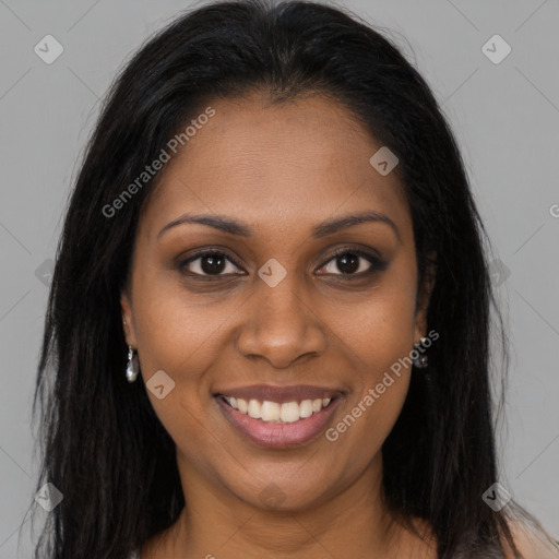 Joyful black young-adult female with long  brown hair and brown eyes