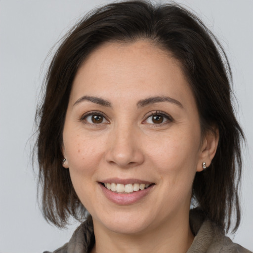 Joyful white young-adult female with medium  brown hair and brown eyes