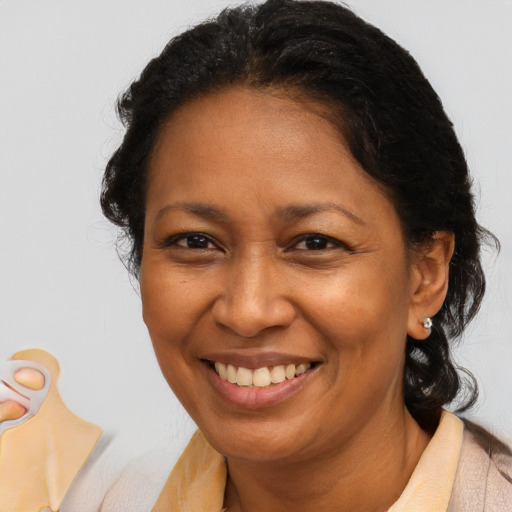 Joyful latino adult female with medium  brown hair and brown eyes