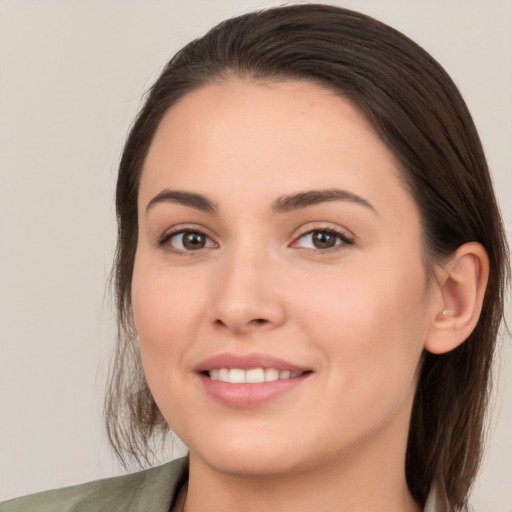 Joyful white young-adult female with medium  brown hair and brown eyes