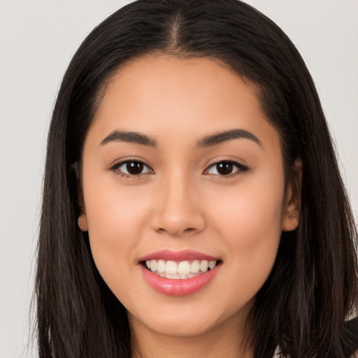 Joyful white young-adult female with long  brown hair and brown eyes