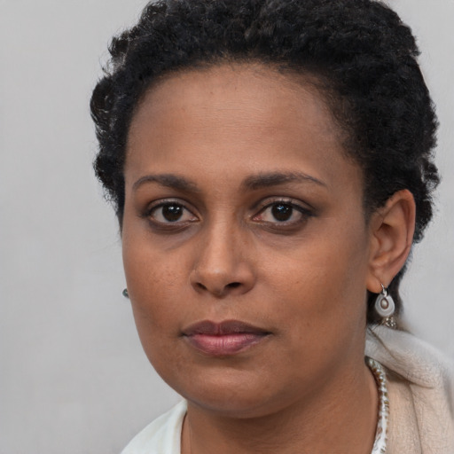 Neutral black young-adult female with short  black hair and brown eyes