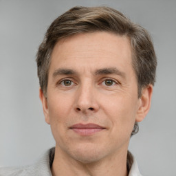 Joyful white adult male with short  brown hair and grey eyes