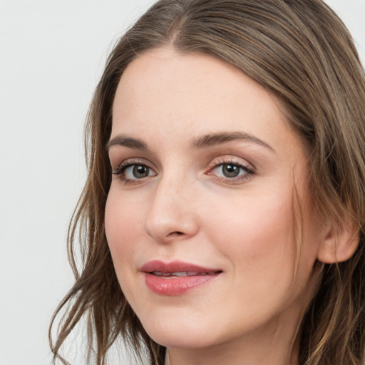 Joyful white young-adult female with long  brown hair and grey eyes