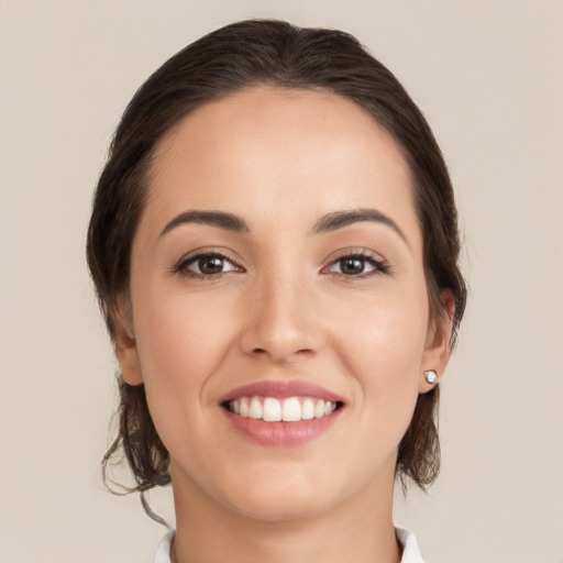 Joyful white young-adult female with medium  brown hair and brown eyes