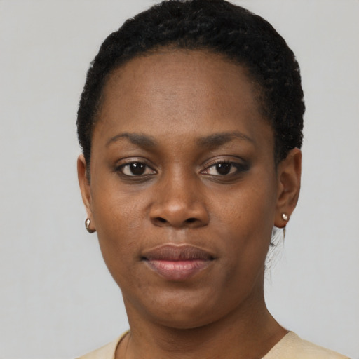 Joyful black young-adult female with short  black hair and brown eyes