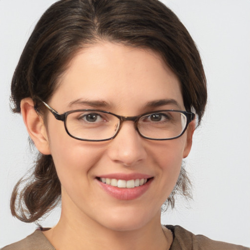 Joyful white young-adult female with medium  brown hair and brown eyes