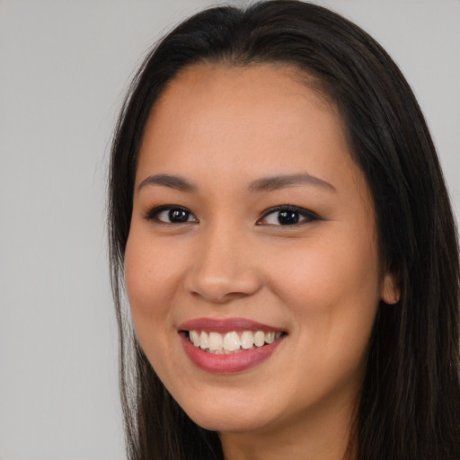 Joyful asian young-adult female with long  brown hair and brown eyes