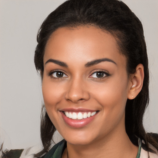 Joyful latino young-adult female with medium  brown hair and brown eyes