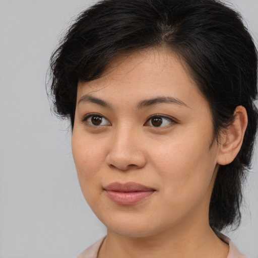 Joyful asian young-adult female with medium  brown hair and brown eyes