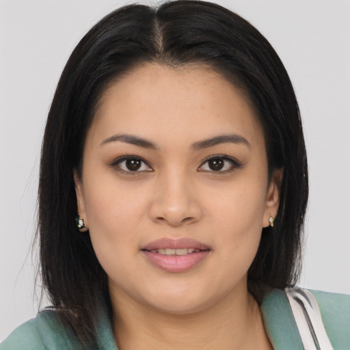 Joyful asian young-adult female with long  brown hair and brown eyes