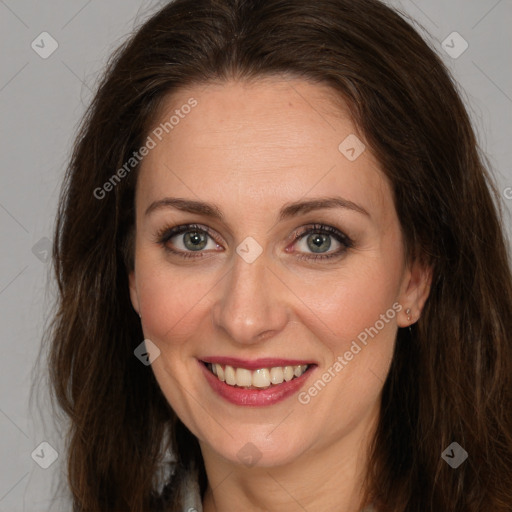 Joyful white adult female with long  brown hair and brown eyes