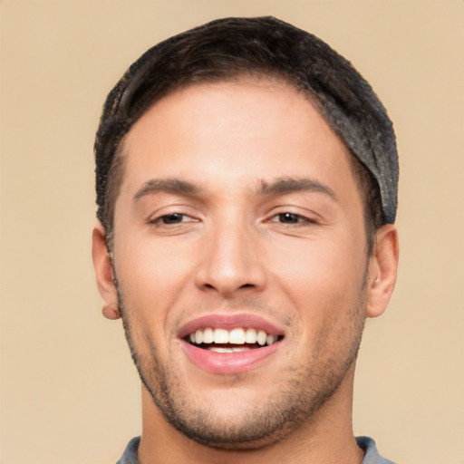 Joyful white young-adult male with short  black hair and brown eyes