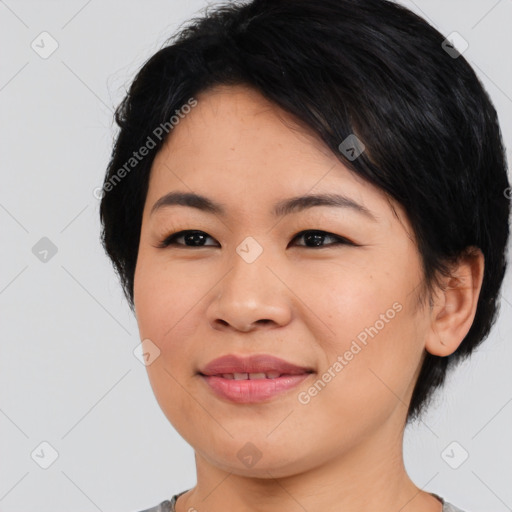 Joyful asian young-adult female with medium  black hair and brown eyes