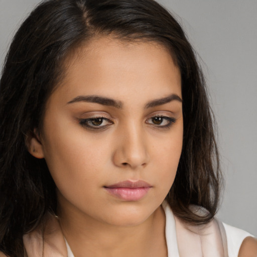 Neutral latino young-adult female with long  brown hair and brown eyes