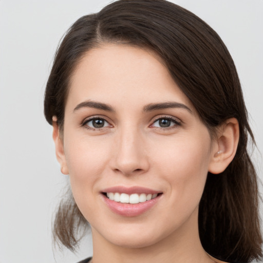 Joyful white young-adult female with medium  brown hair and brown eyes