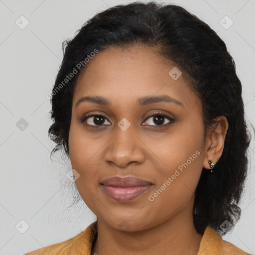 Joyful black young-adult female with long  black hair and brown eyes