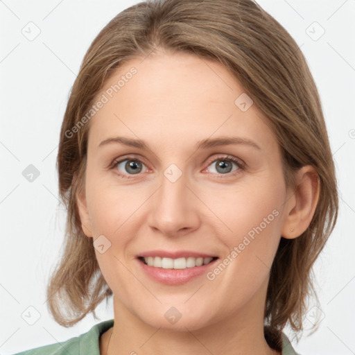 Joyful white young-adult female with medium  brown hair and grey eyes