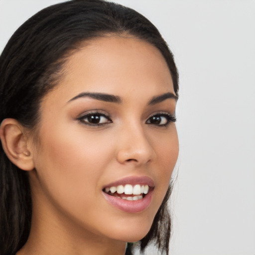 Joyful latino young-adult female with long  brown hair and brown eyes