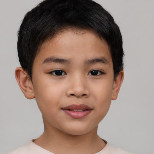 Joyful asian child male with short  brown hair and brown eyes