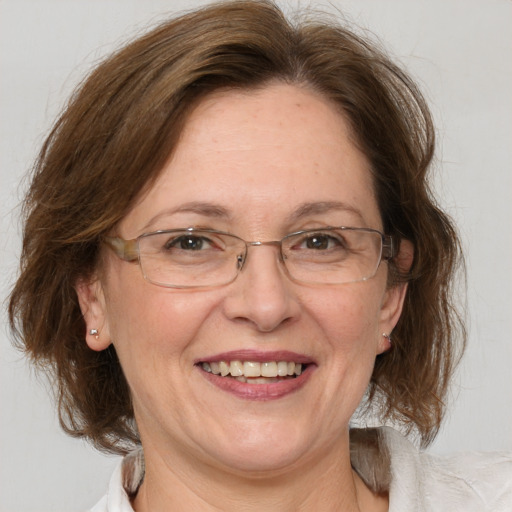 Joyful white middle-aged female with medium  brown hair and brown eyes