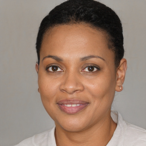 Joyful black young-adult female with short  brown hair and brown eyes