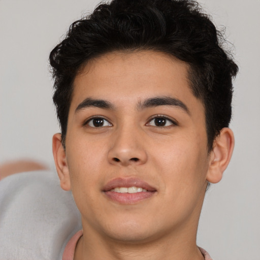 Joyful latino young-adult male with short  brown hair and brown eyes