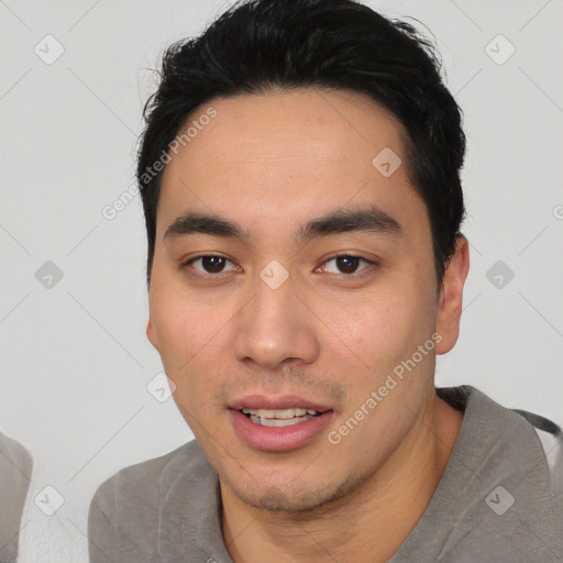 Joyful white young-adult male with short  black hair and brown eyes