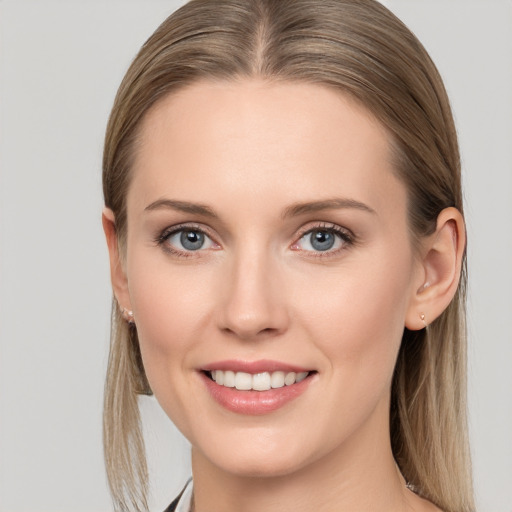 Joyful white young-adult female with long  brown hair and blue eyes