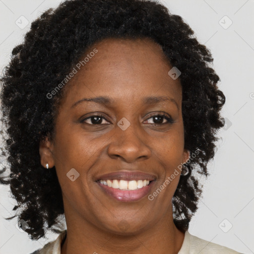 Joyful black adult female with medium  brown hair and brown eyes