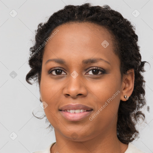 Joyful black young-adult female with medium  brown hair and brown eyes