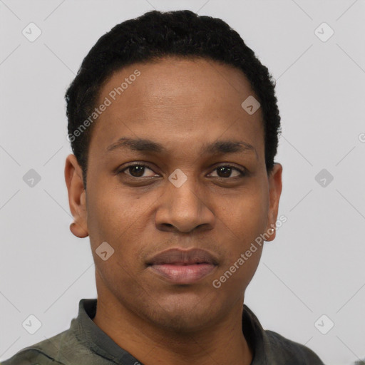 Joyful black young-adult male with short  black hair and brown eyes